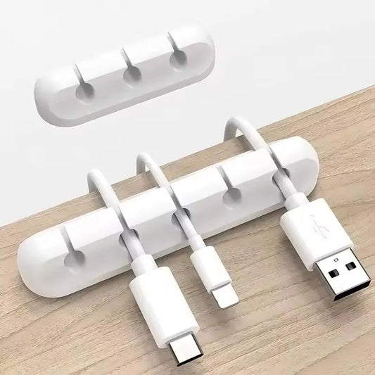 Silicone cable holder clip holding a USB cable on a desk