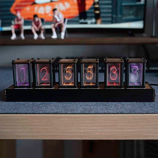 Nixie-style glow clock lit up on a desk setting