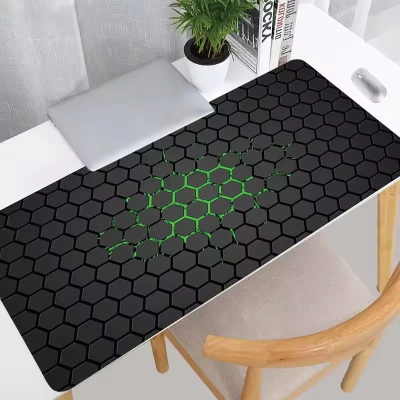 Hexagon pattern gaming desk mat laid across a desk under a keyboard and mouse