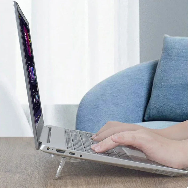Two small foldable stick-on risers tilting the back of a laptop