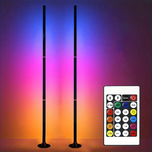 Slim RGB corner floor lamp lighting a wall in color behind a gaming desk