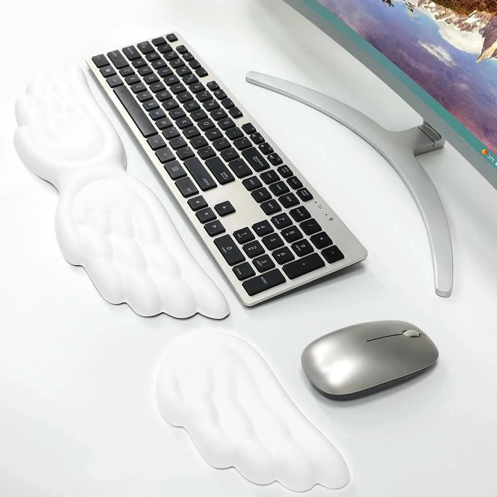Angel wing wrist rest set on a desk beside a keyboard