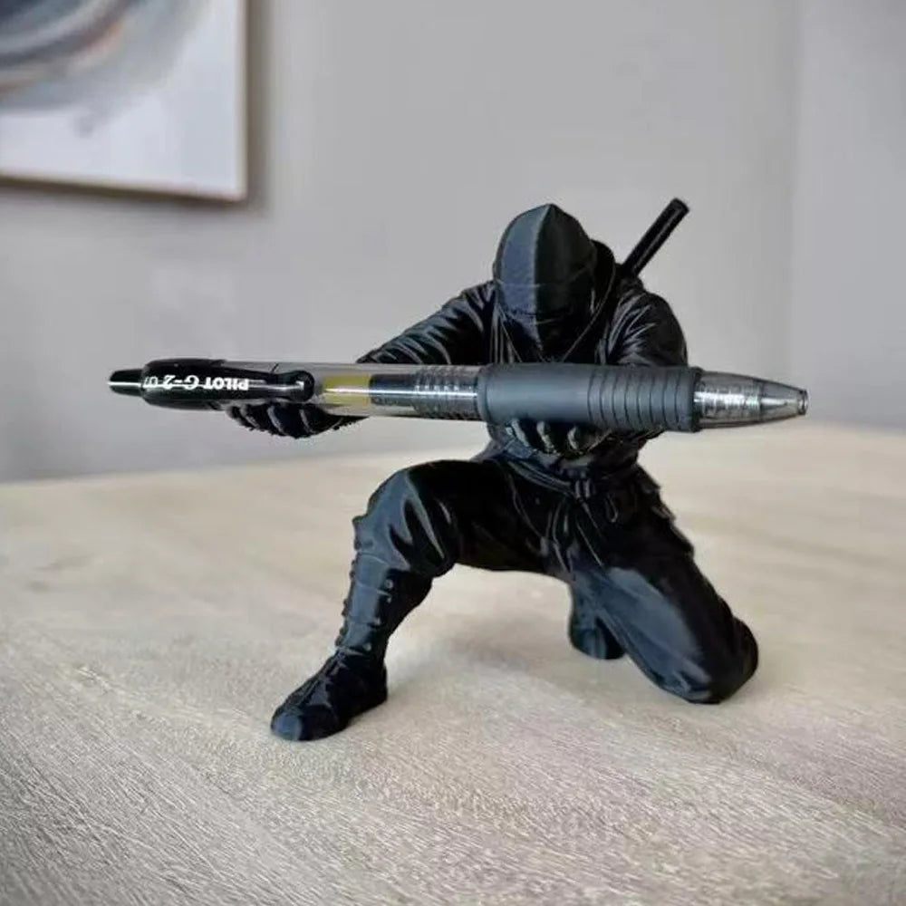 3D printed ninja figure pen holder holding pens on a desk