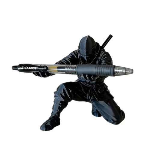 3D printed ninja figure pen holder holding pens on a desk