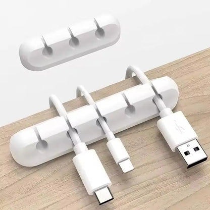 Silicone cable holder clip holding a USB cable on a desk