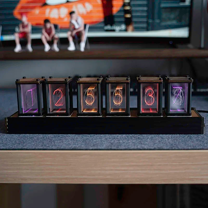 Nixie-style glow clock lit up on a desk setting