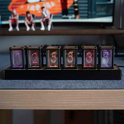 Nixie-style glow clock lit up on a desk setting