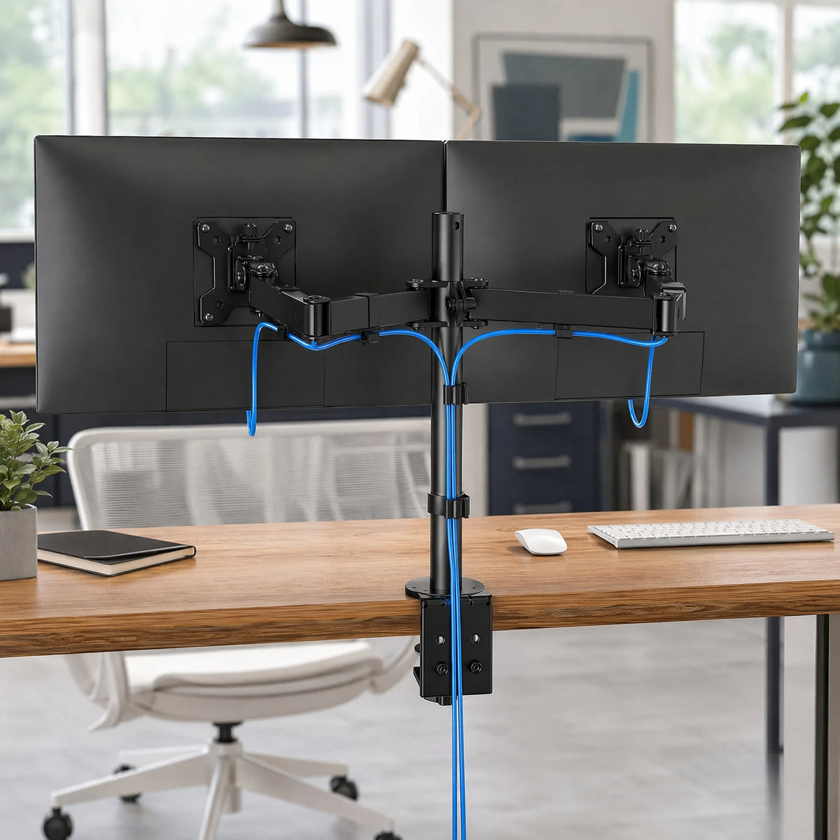 Dual monitor arm holding two screens above a desk