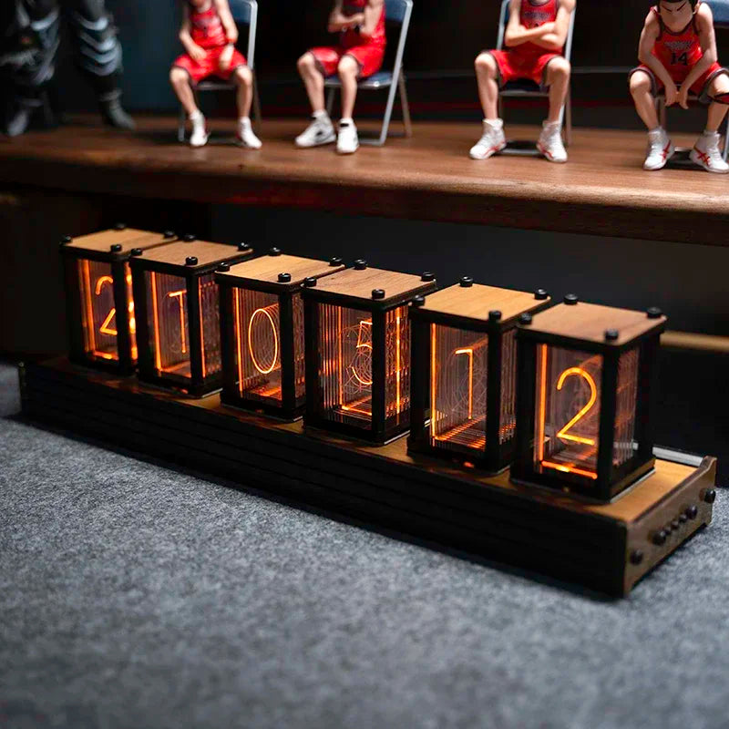 Nixie-style glow clock with figurines placed on top of the case