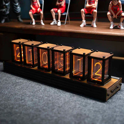 Nixie-style glow clock with figurines placed on top of the case
