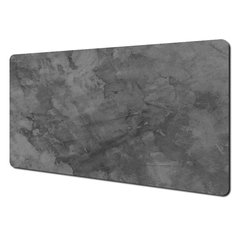 Gray cloth desk mat with stitched edges under a keyboard and mouse