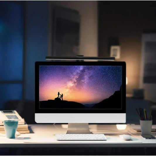 Light bar mounted on a monitor, lighting a desk at night