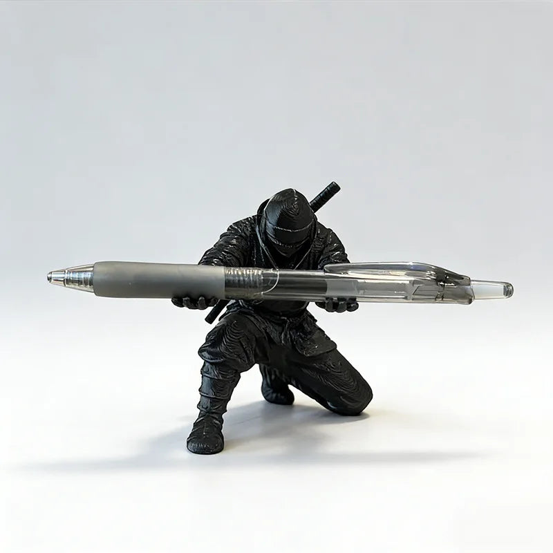 3D printed ninja figure pen holder holding pens on a desk