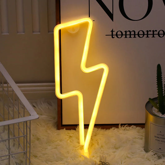 Yellow lightning bolt neon light next to a poster