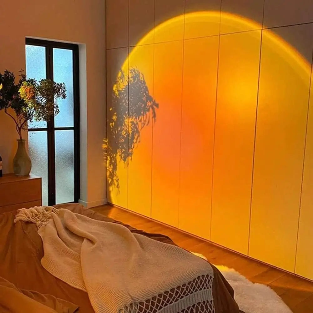 USB sunset projection lamp casting a warm round glow on a wall behind a desk