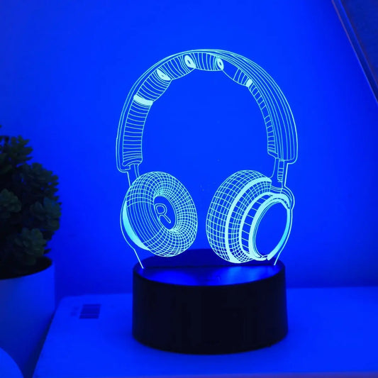 Headphones night light glowing blue on a lit base in a dark room