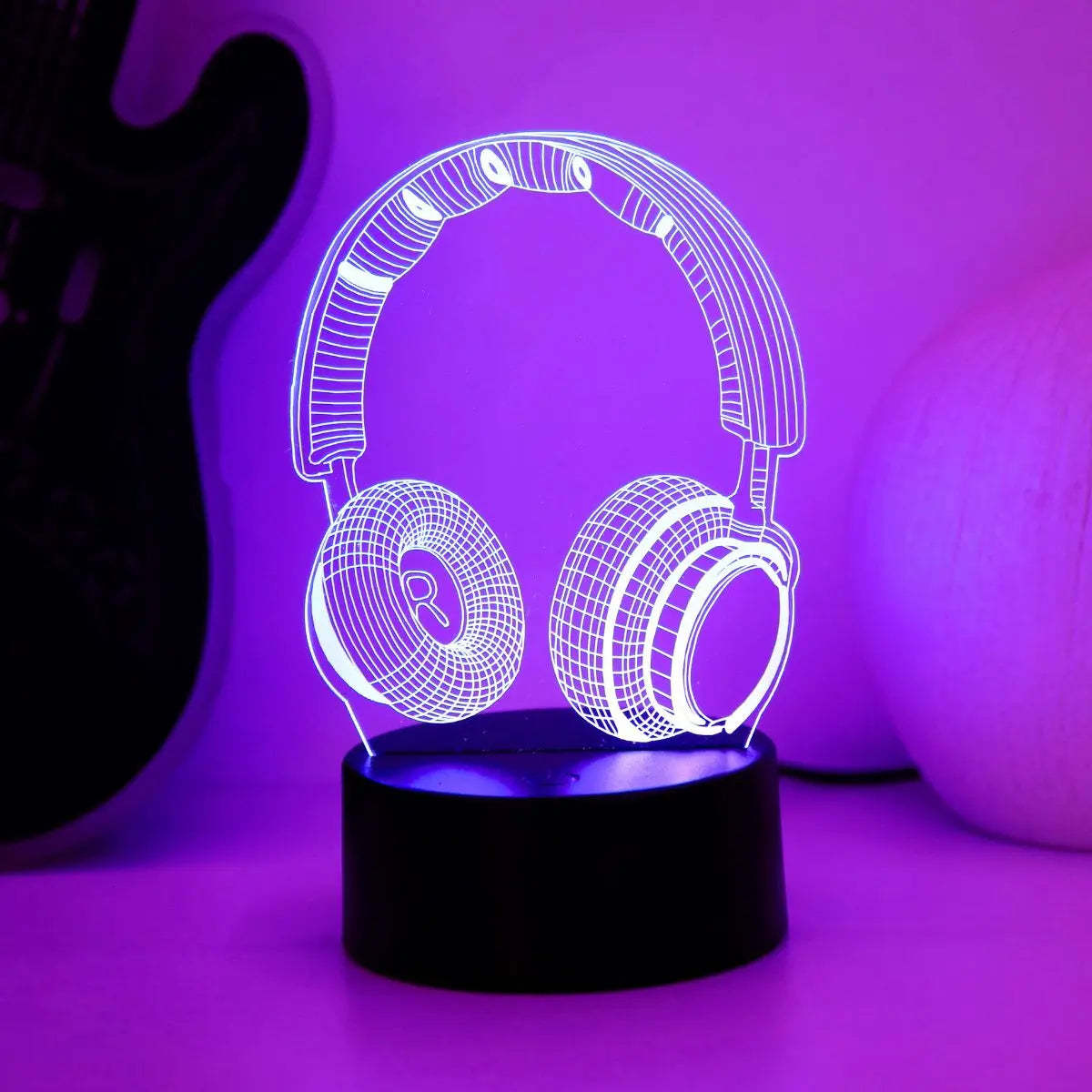 Headphones night light glowing purple on a lit base