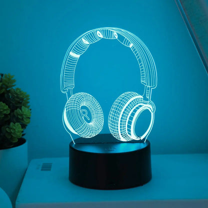 Headphones night light glowing teal on a lit base